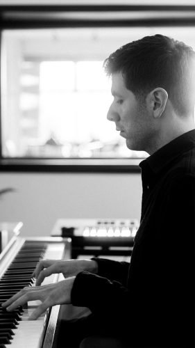 Person playing keyboard in black and white